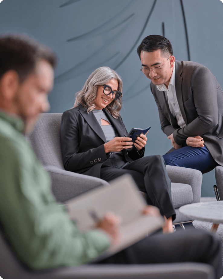 three people sitting in lobby working